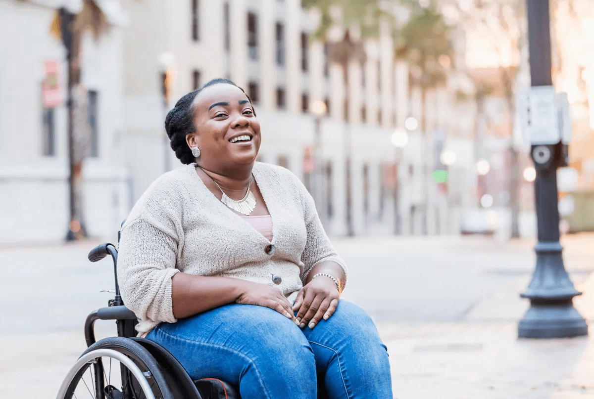 Saige Care Solutions support worker assisting a participant outdoors
